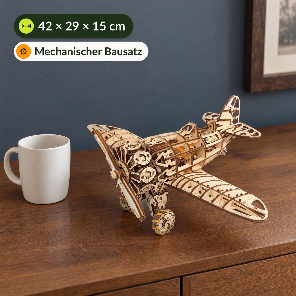 Mechanical airplane, finished wooden model next to a cup on the sideboard, measuring 42 × 29 × 15 cm