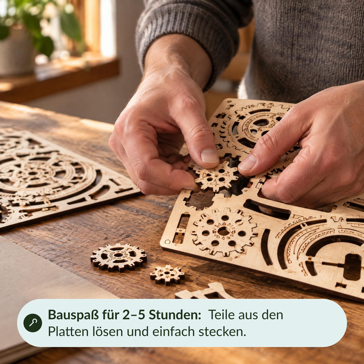 Hands remove a gear from a wooden board on the workbench—fun building with the Globus kit