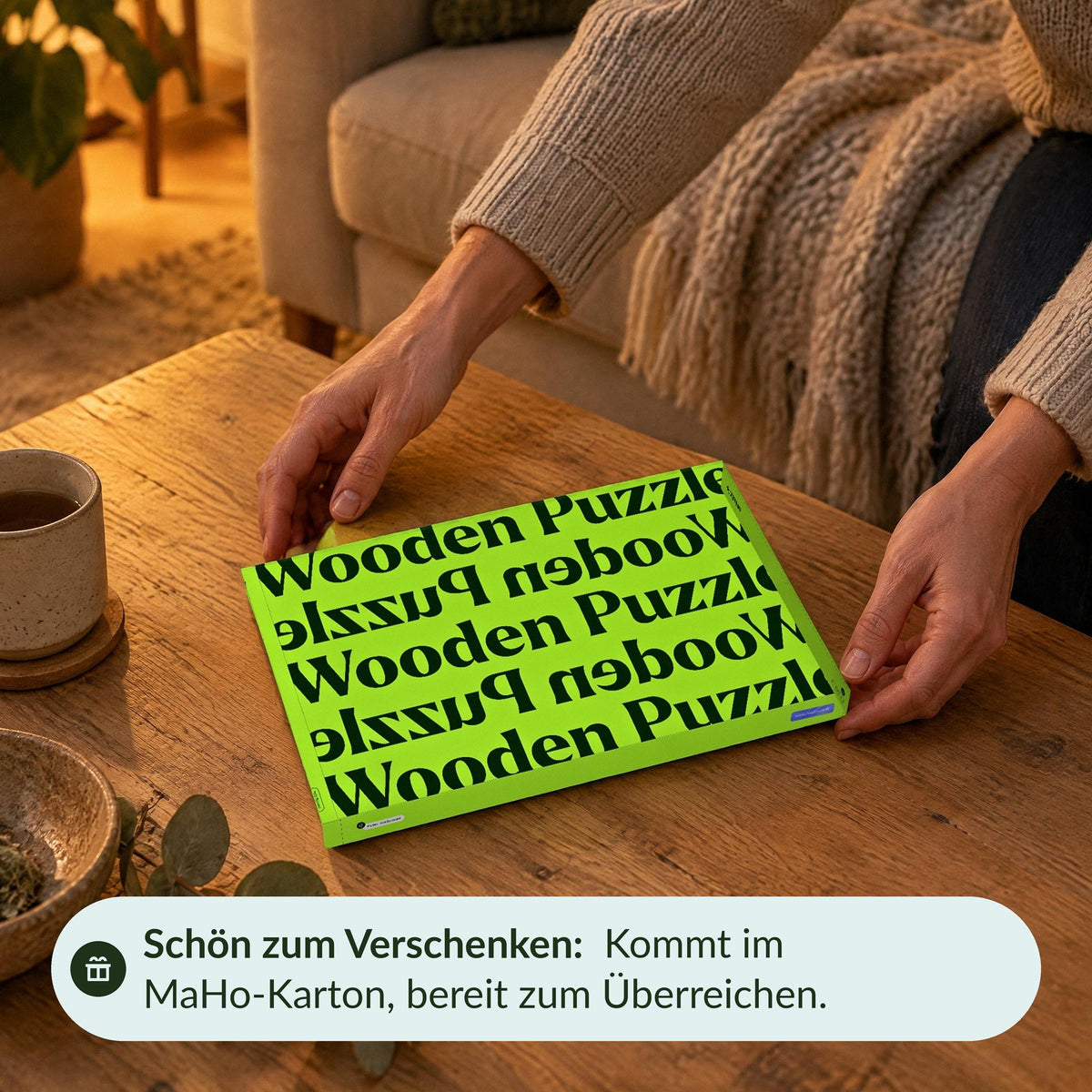A special moment by the coffee table: Hands set down the closed green MaHo box containing the globe kit