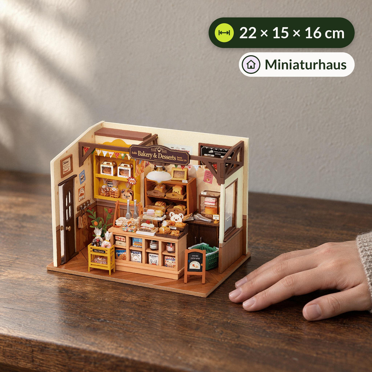 Becka’s Baking House (Bakery) Miniature House, size comparison with a hand on a desk, 22 × 15 × 16 cm