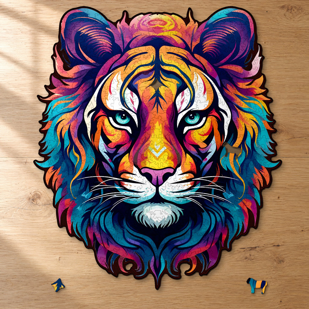 The majestic "Kindness of the Tiger" wooden puzzle, almost complete on light oak, with two puzzle pieces in front of it: a star and a big cat