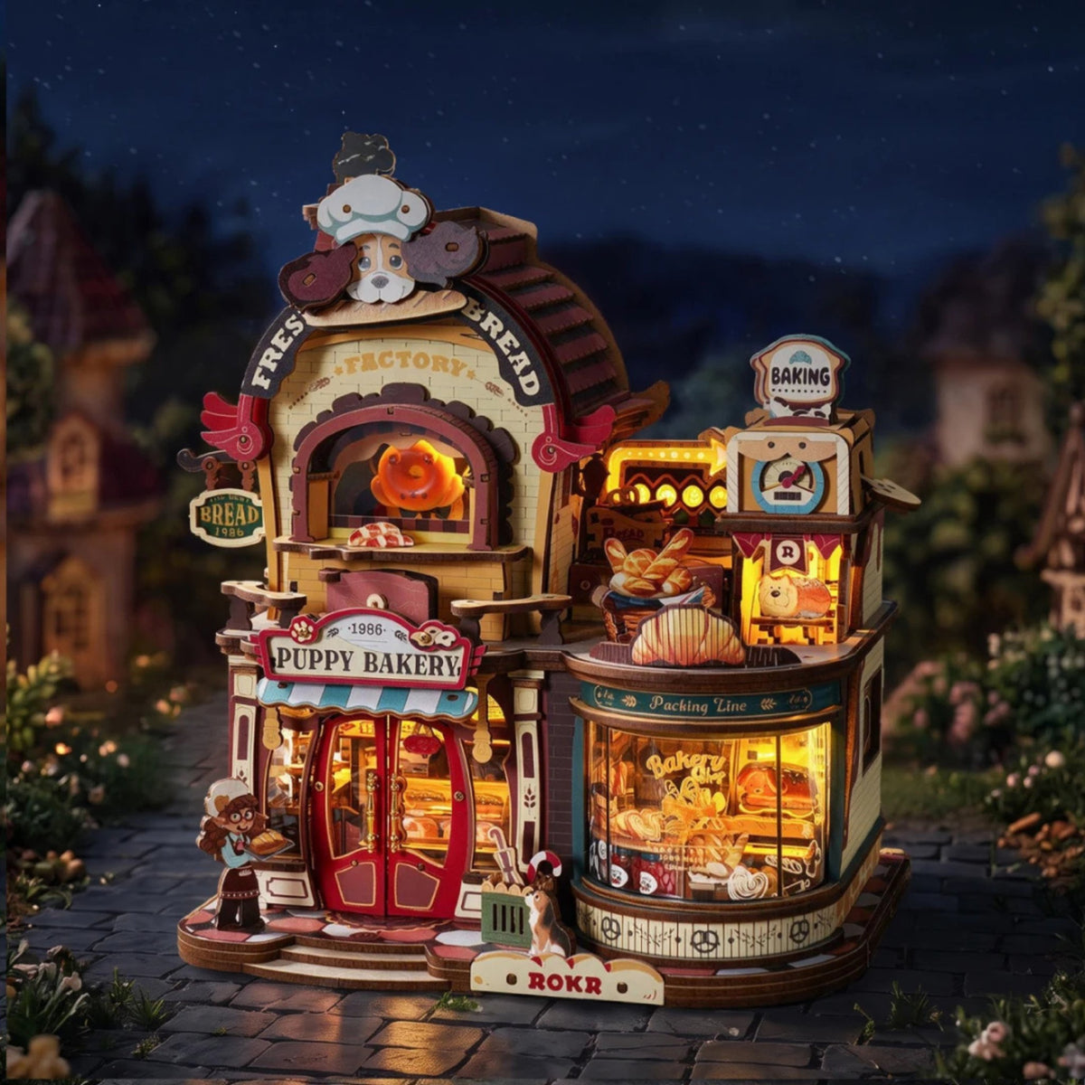 Dream Bread Factory 3D - «Maquette en bois » la nuit, four illuminé et fenêtres de la boulangerie en bois qui brillent d'une lueur chaleureuse