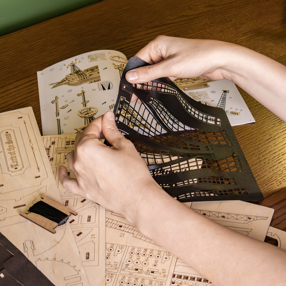 "Lord of the Seas" Wooden Model Kit; when building, use your hands to lift the black sail out of the sheet; included are instructions and parts sheets