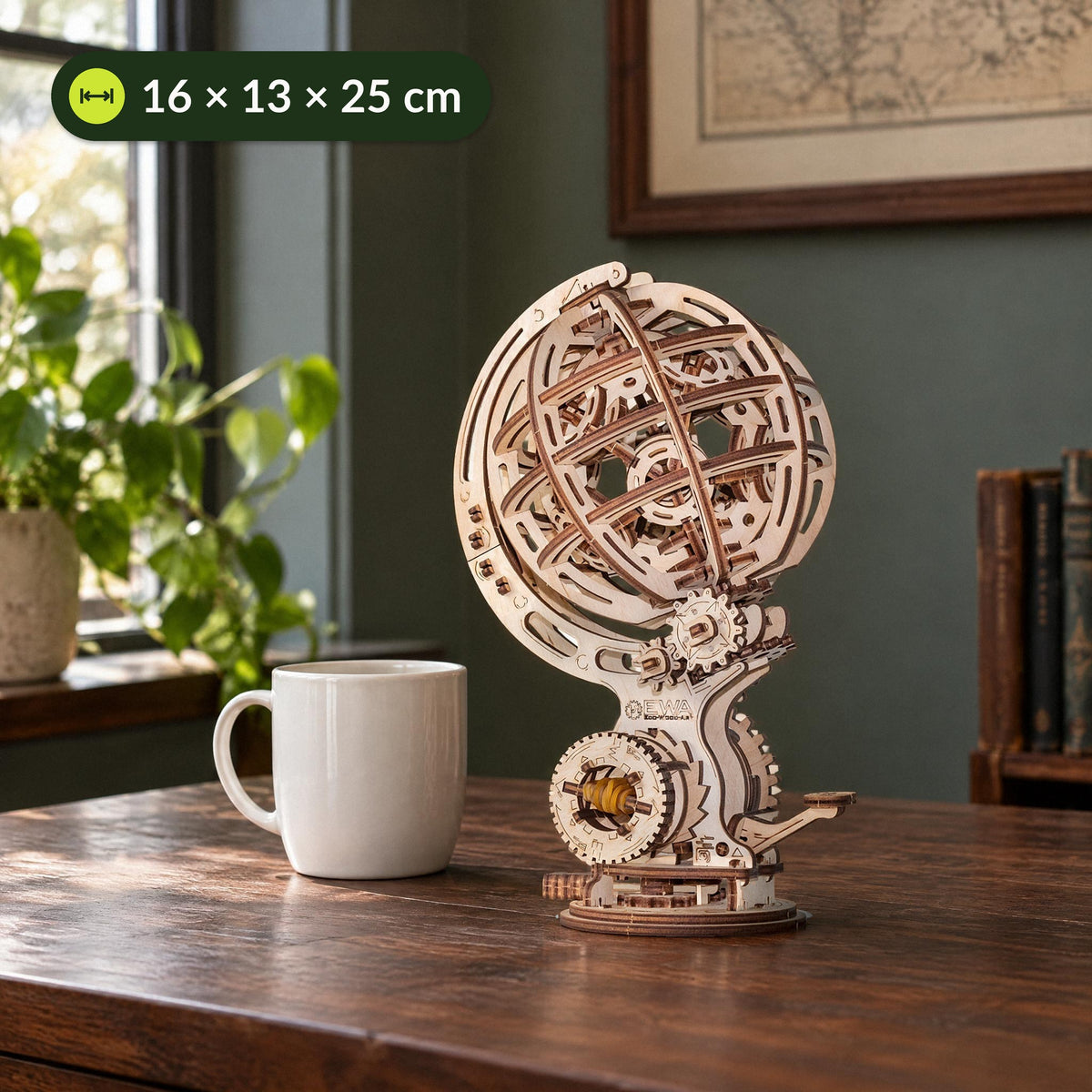 A kinetic globe next to a coffee cup on the desk, measuring 16 × 13 × 25 cm, made of wood