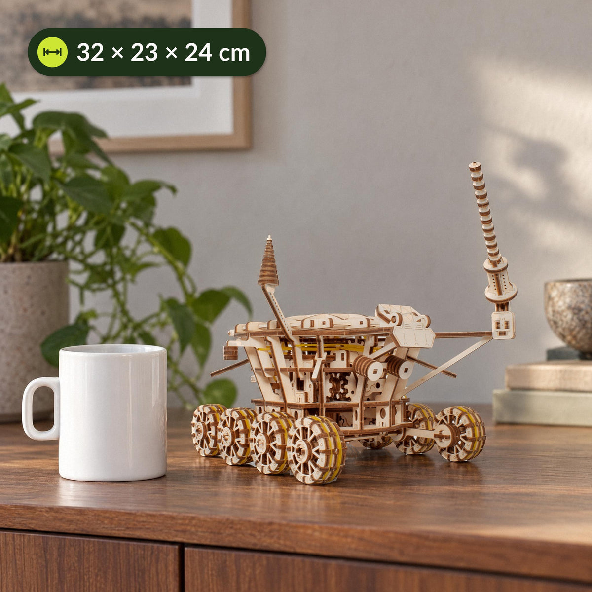 Wooden Lunokhod lunar rover next to a coffee cup for size comparison; the model measures 32 × 23 × 24 cm