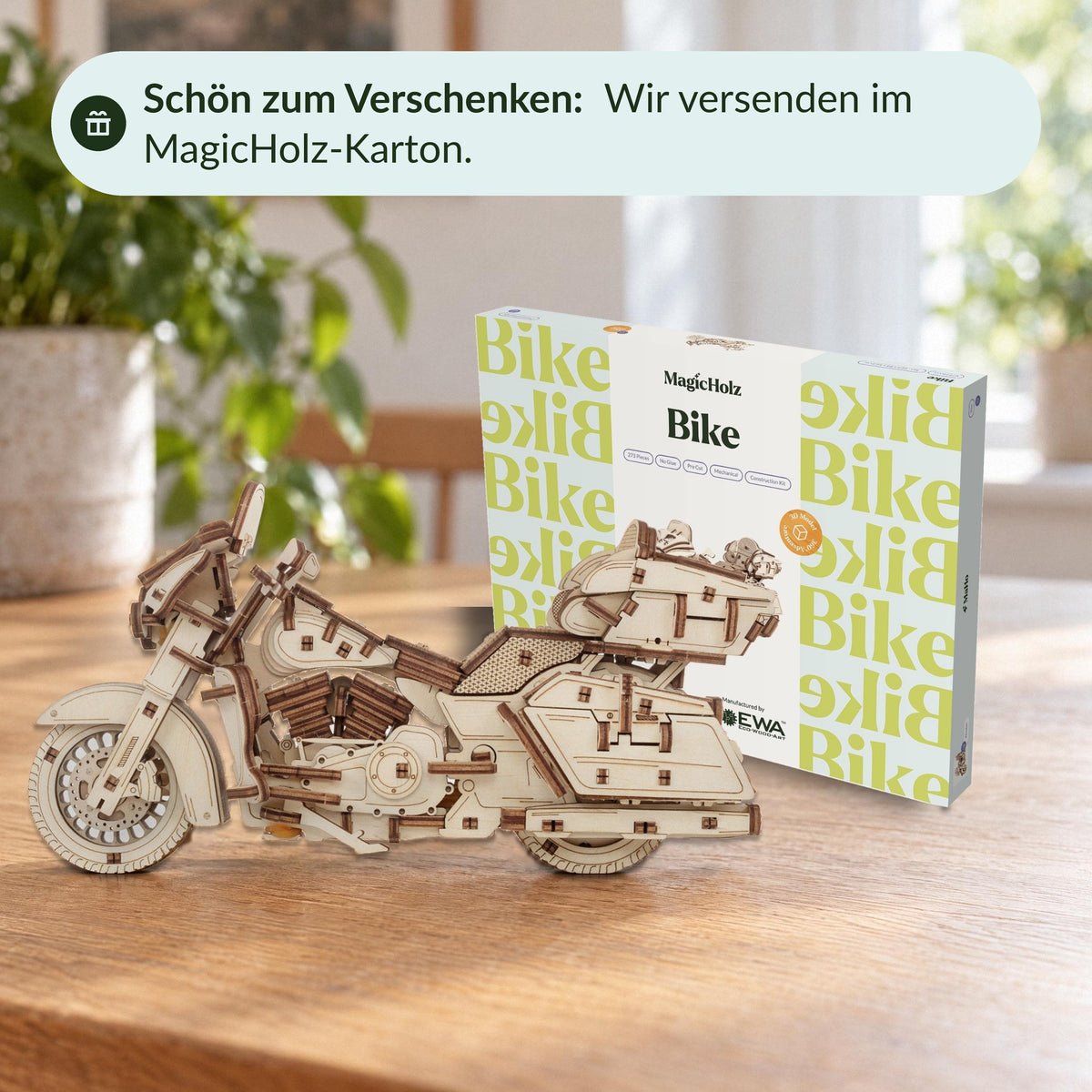 Wooden motorcycle model on the dining table in front of the " MagicHolz" box featuring a motorcycle design—a lovely gift
