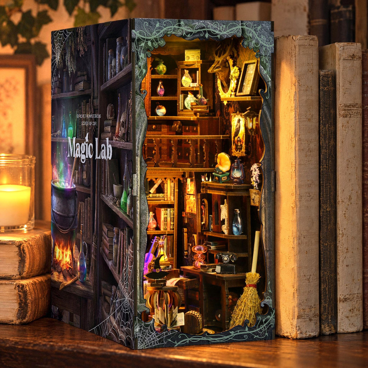 Magic Lab Book Nook, glowing on the shelf in the evening among old books, next to it an LED candle in a glass jar and ivy