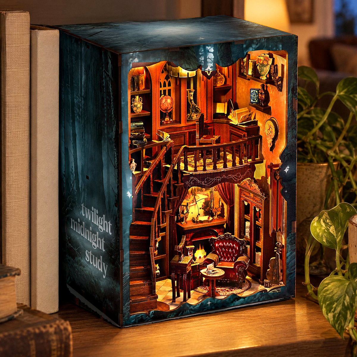 Twilight Midnight Study Book Nook glows on the bookshelf in the evening, with a side panel featuring a forest motif and lettering