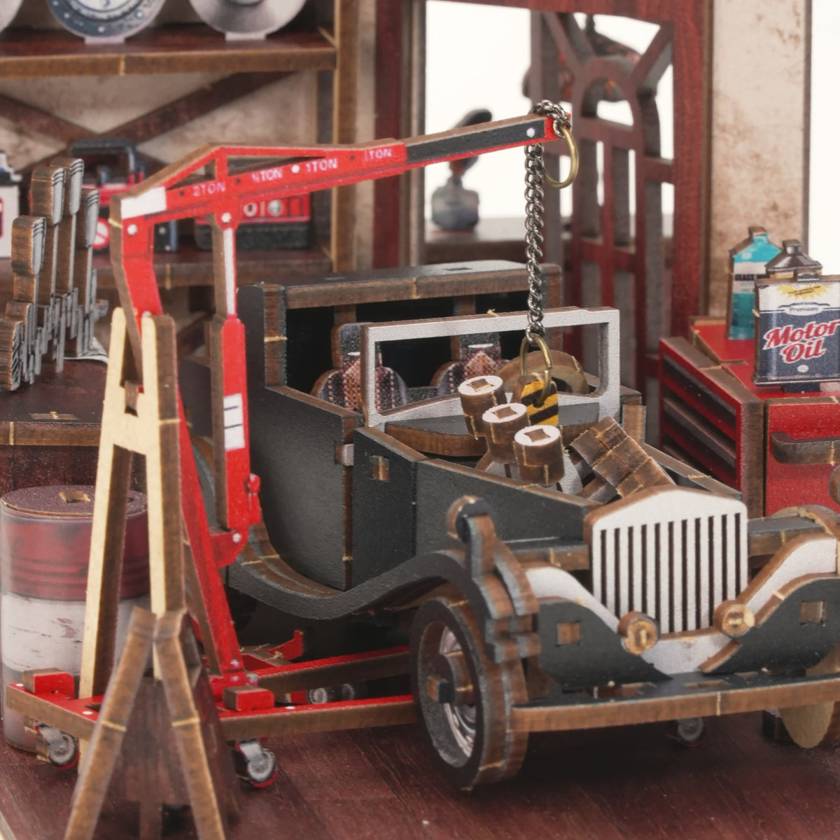 Vintage Car Mechanic Book Nook, A Glimpse Inside the Workshop: A red engine hoist above a black classic car, oil can