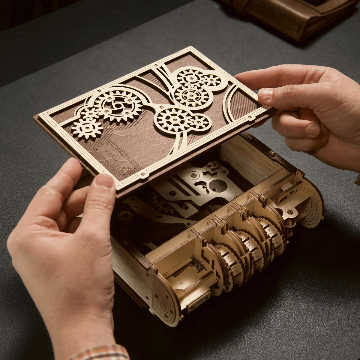 During assembly, use your hands to place the book cover with gears onto the lock mechanism of the Book of Secrets