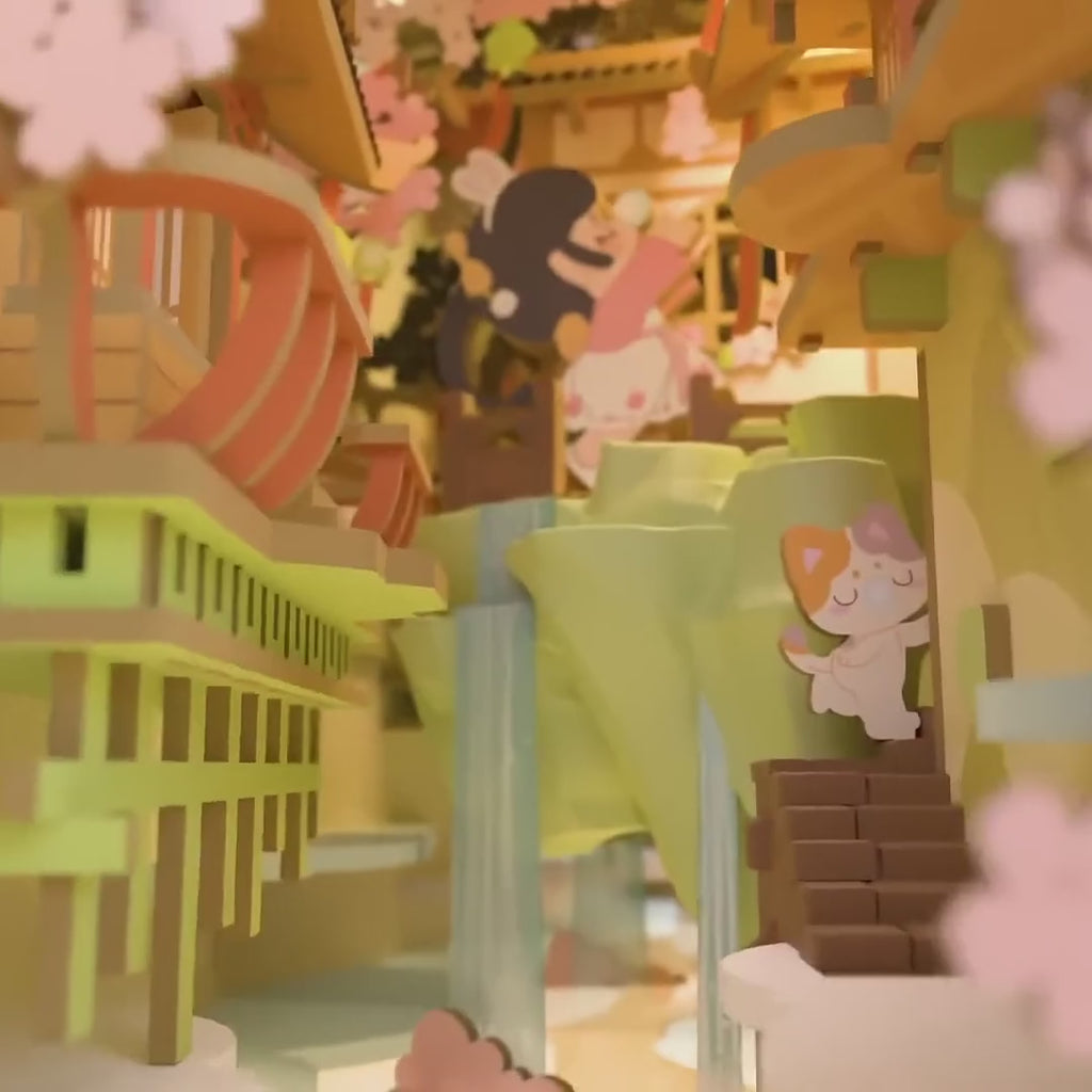 Falling Sakura Book Nook, Video: Kamerafahrt durch die beleuchtete Szene und Hände beim Zusammenbauen