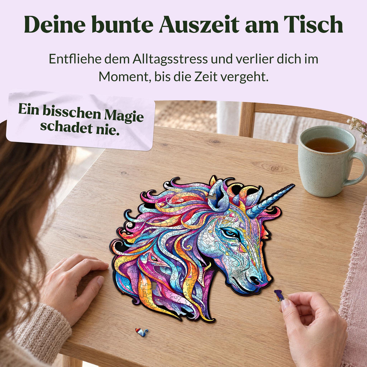 Rainbow Unicorn Wooden Puzzle; a woman is putting together the puzzle at a light oak table and placing a dog-shaped piece into the puzzle