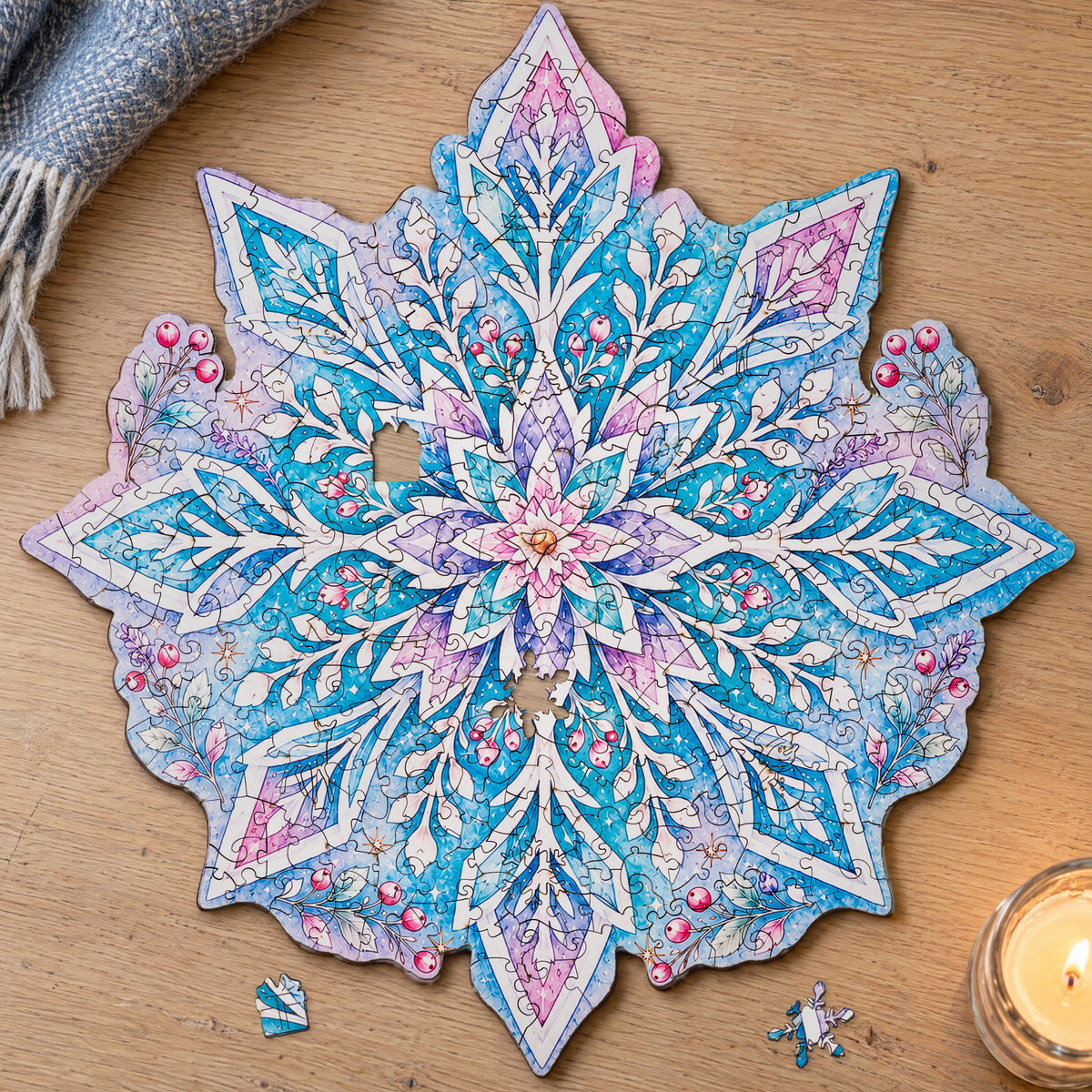Schneeflocken Mandala Holzpuzzle, fertig gelegt auf hellem Eichentisch, davor zwei Figurenteile: Schneeflocke und Geschenk