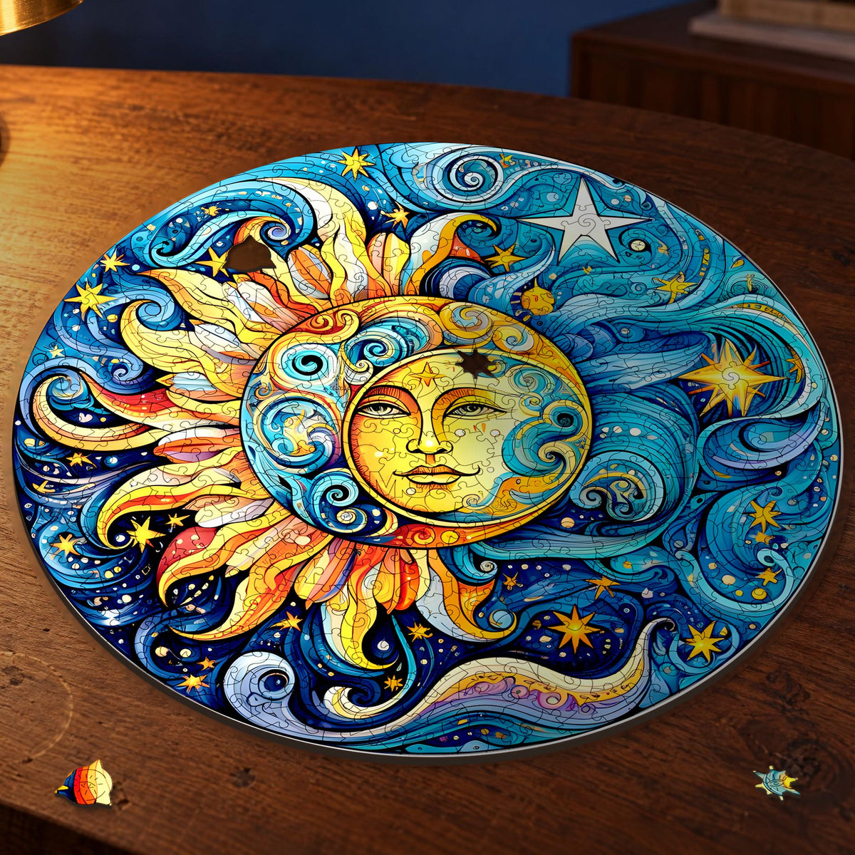 Sun and Moon Mandala Wooden Puzzle, round and almost finished on a walnut surface in the lamplight, with two puzzle pieces lying in front of it