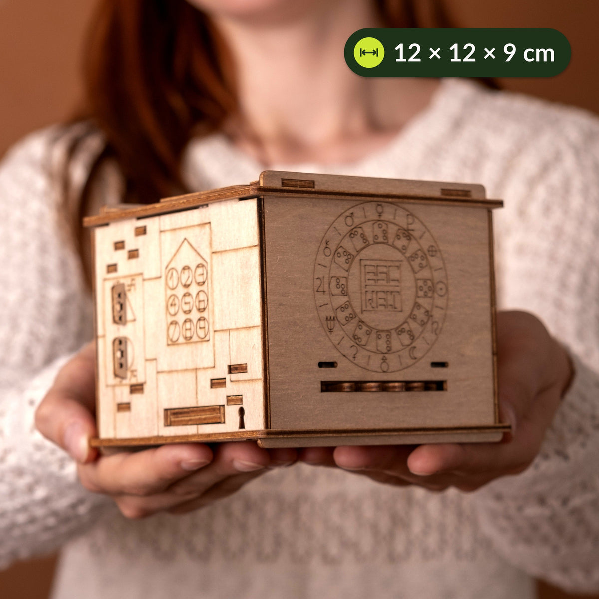 Space Box Riddle Box held in both hands, about 12 cm wide and 9 cm tall, with an engraved symbol disc