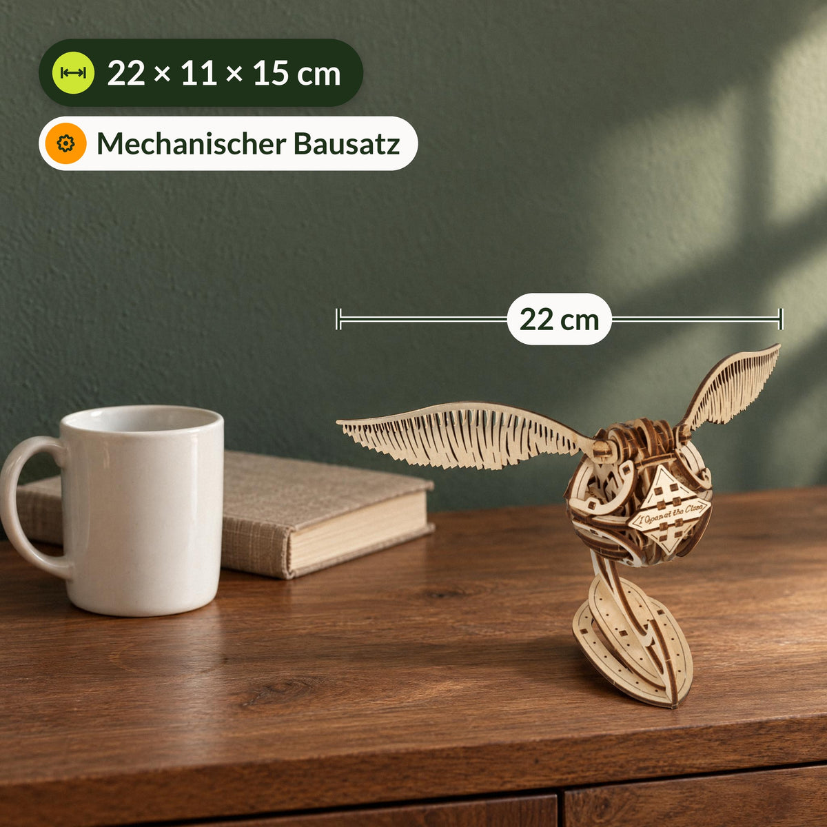 Golden Snitch – Harry Potter, size comparison with a coffee mug on a sideboard, 22 x 11 x 15 cm
